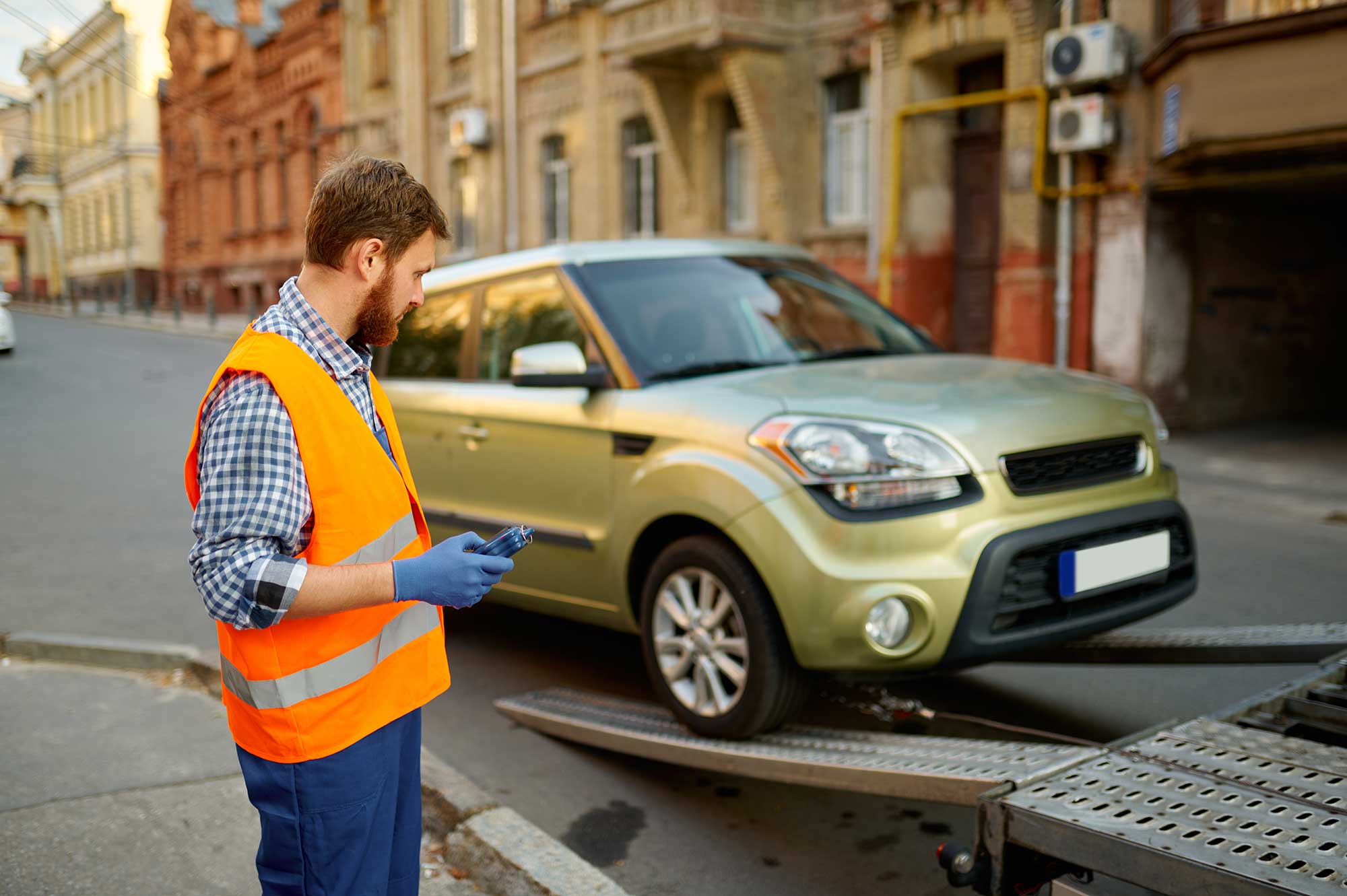 male-road-worker-monitoring-car-loading-process-2022-02-16-17-24-50-utc-1.jpg